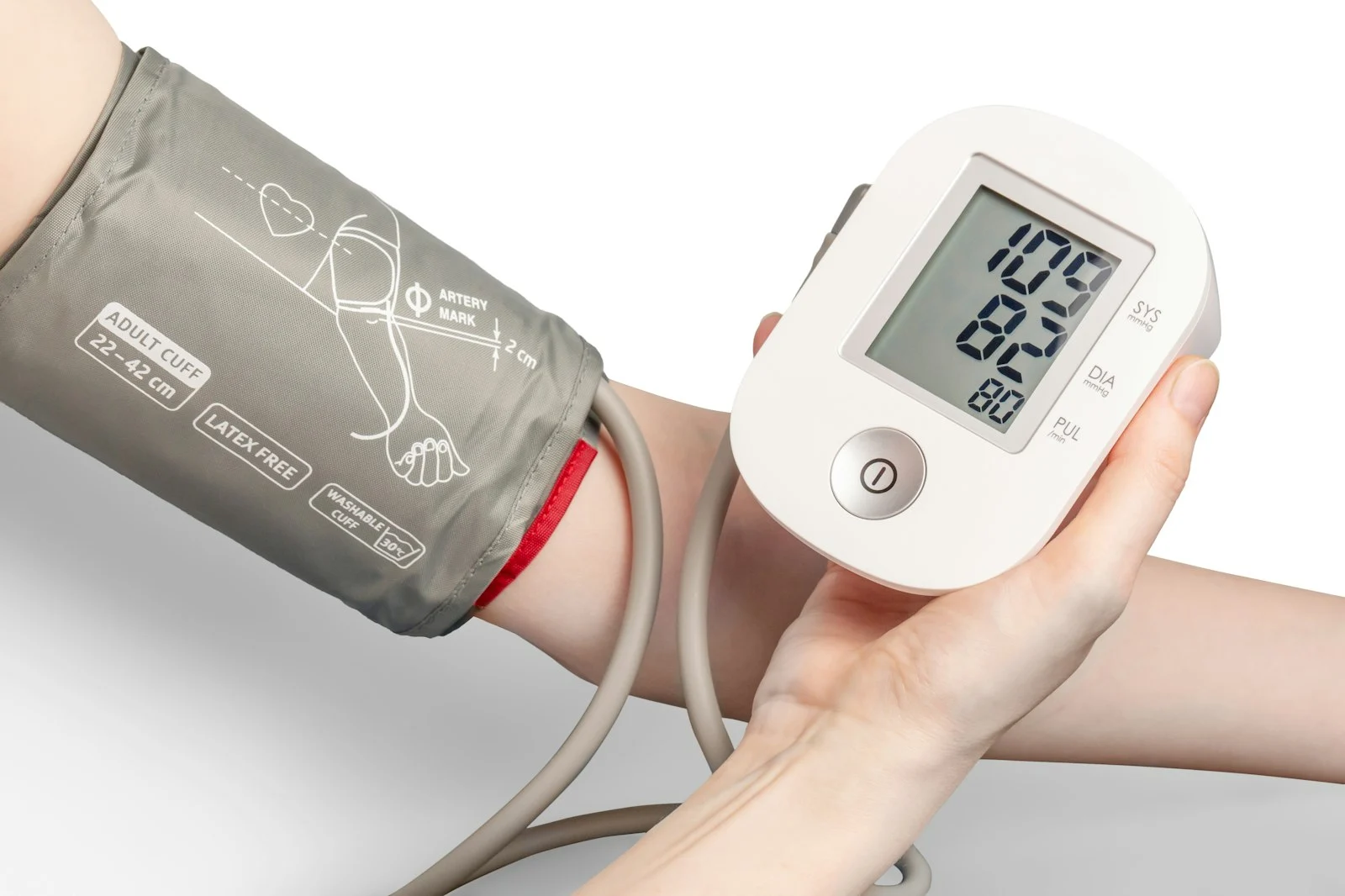 Person checking their blood pressure with a digital monitor and arm cuff