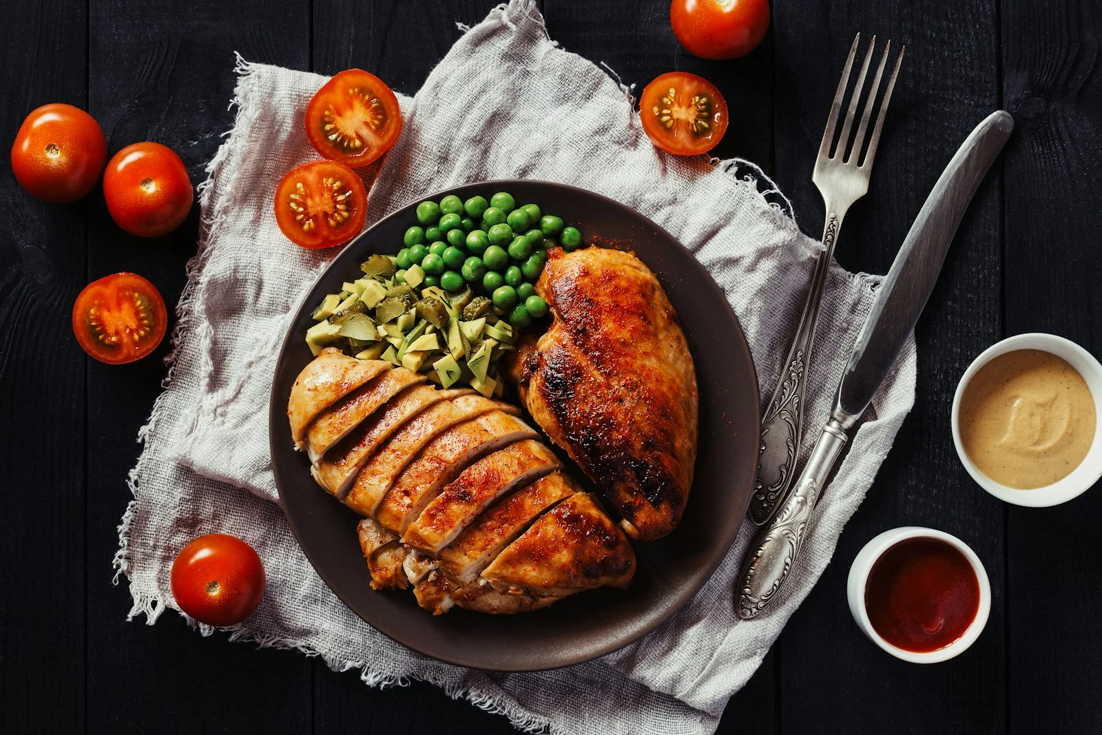 Plate of sliced grilled chicken breast with green peas